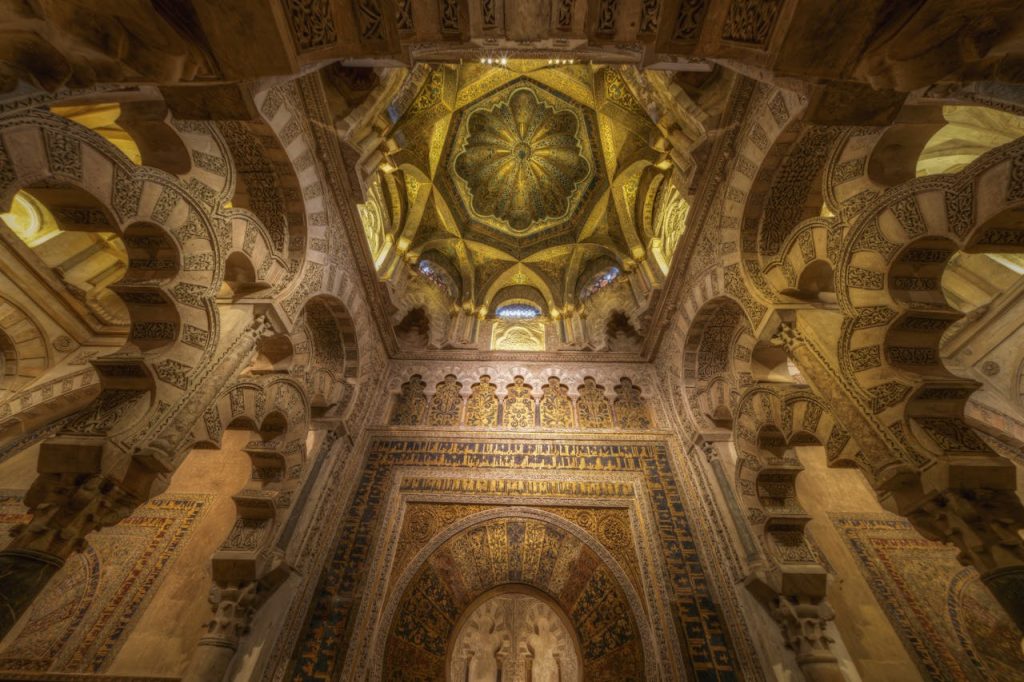 Stunning view of the elaborate arches and decor inside the Mosque-Cathedral of Cordoba, Spain.